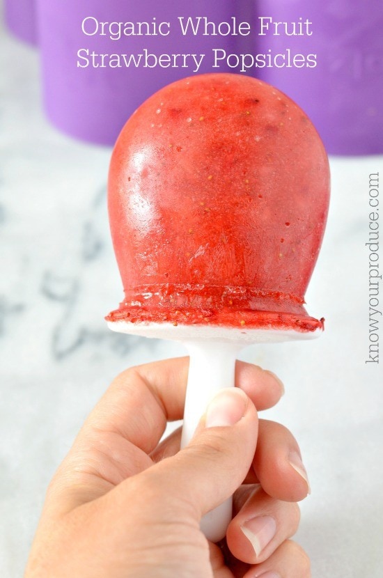 whole fruit strawberry popsicles in a round popsicle mold
