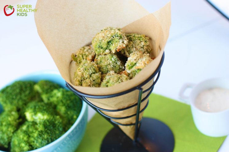 broccoli poppers rolled in bread crumbs and served in a brown paper cone
