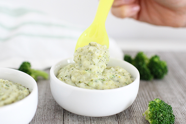 small white bowls of broccoli mashed potatoes being scooped up with a yellow spoon