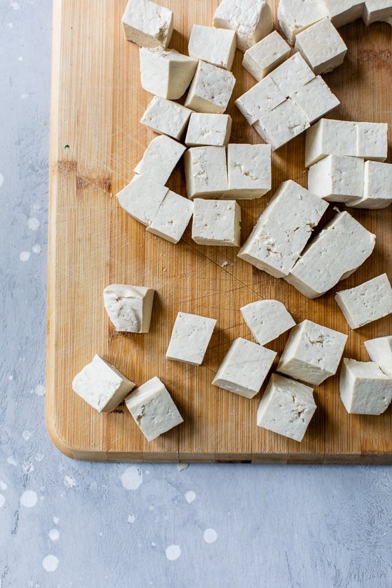 tofu cubes on a cutting board