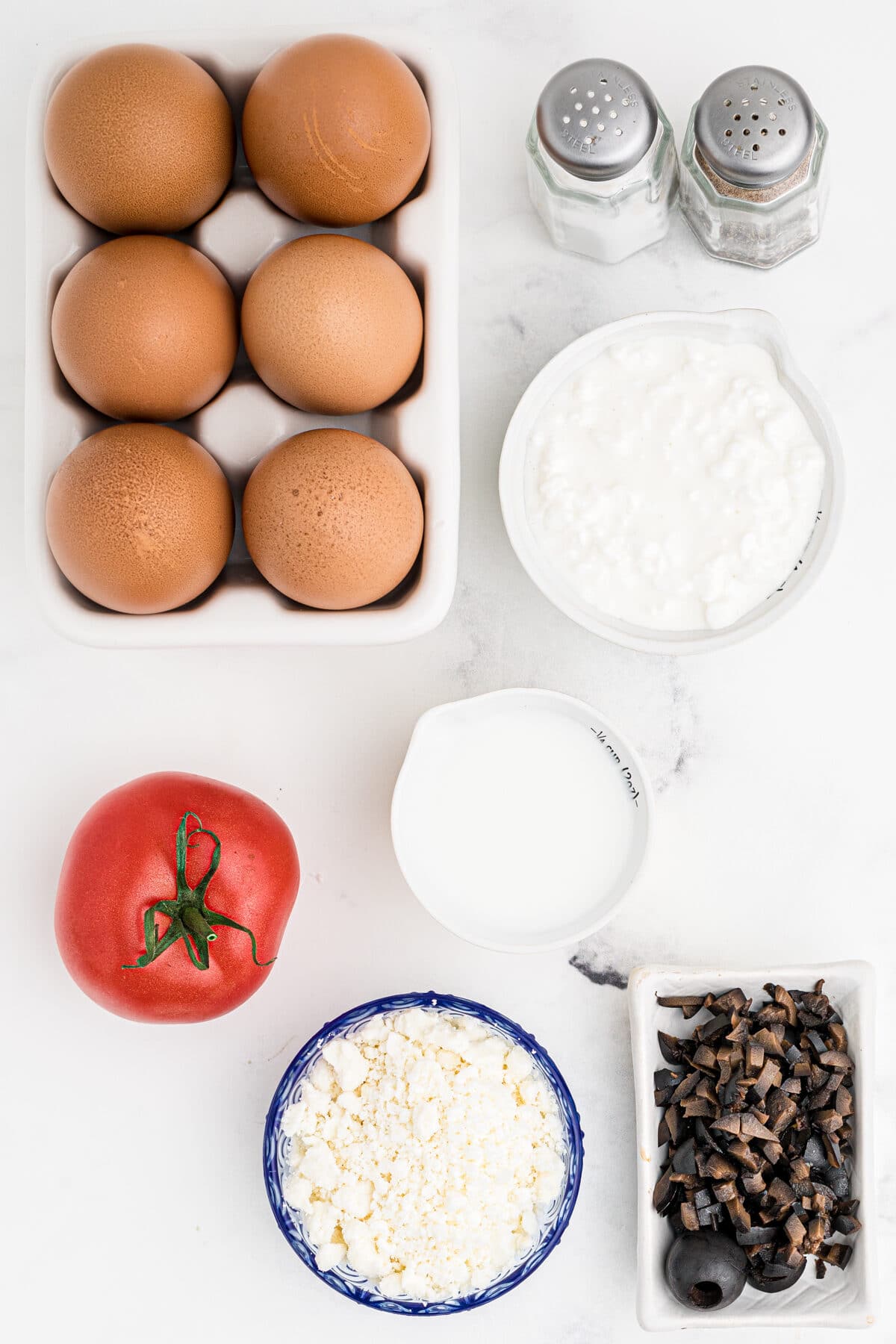 ingredients for Greek breakfast egg cups with feta cheese, kalamata olives and tomatoes