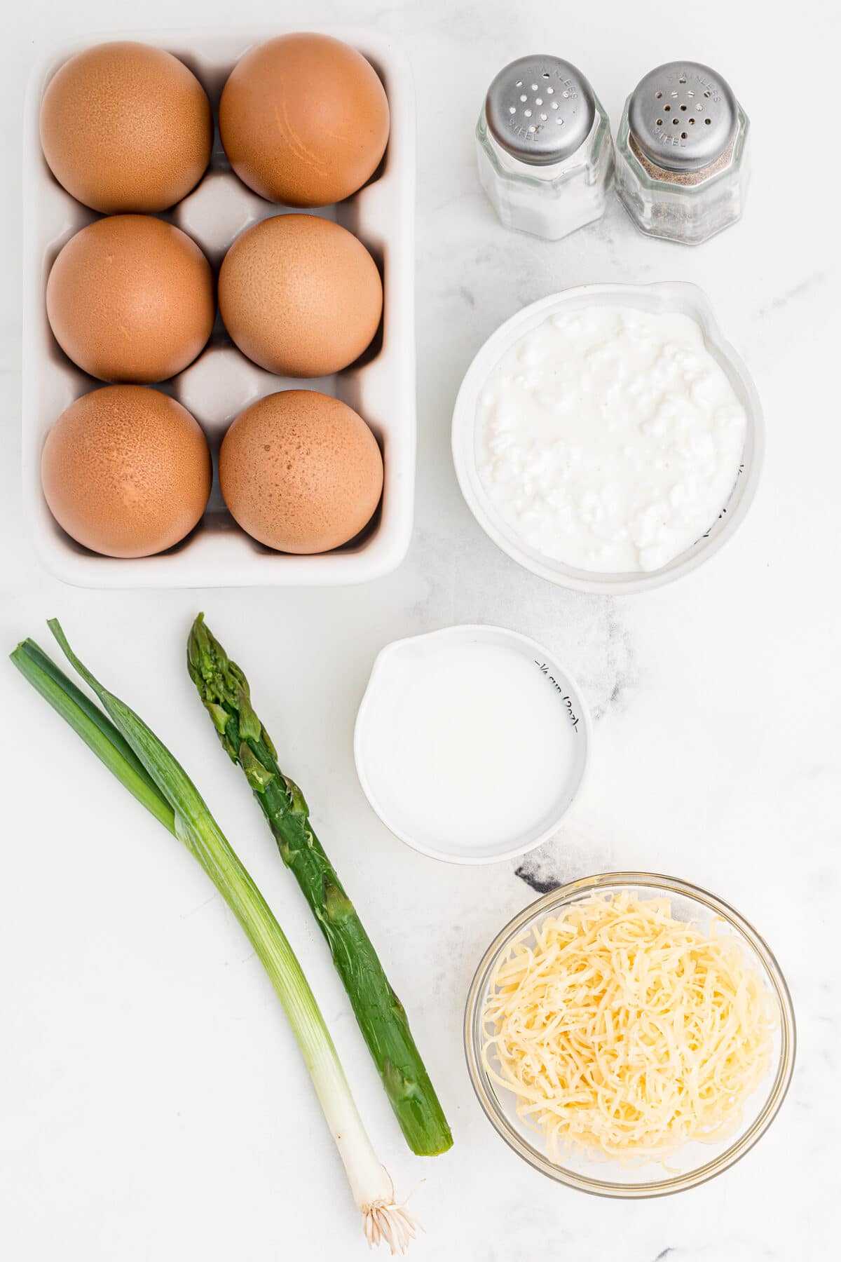 ingredients for french breakfast egg cups, green onion, asparagus, gouda cheese