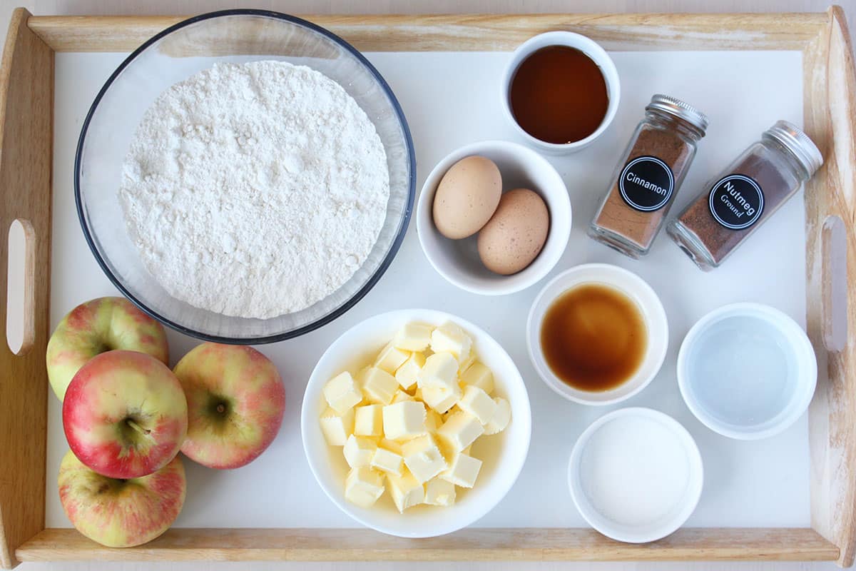 ingredients for caramel apple pie on a white tray