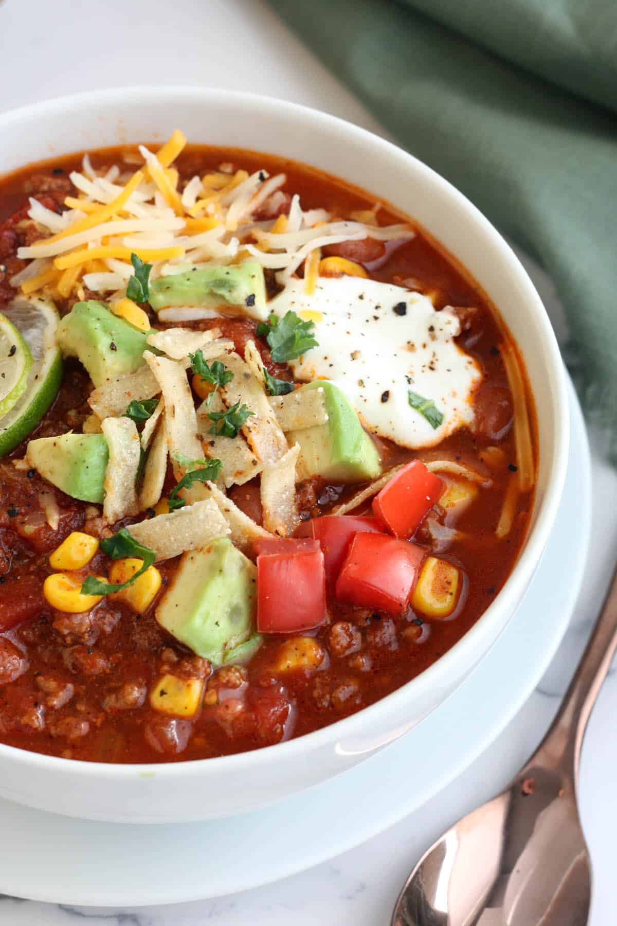 a bowl of best ever taco soup in a white bowl