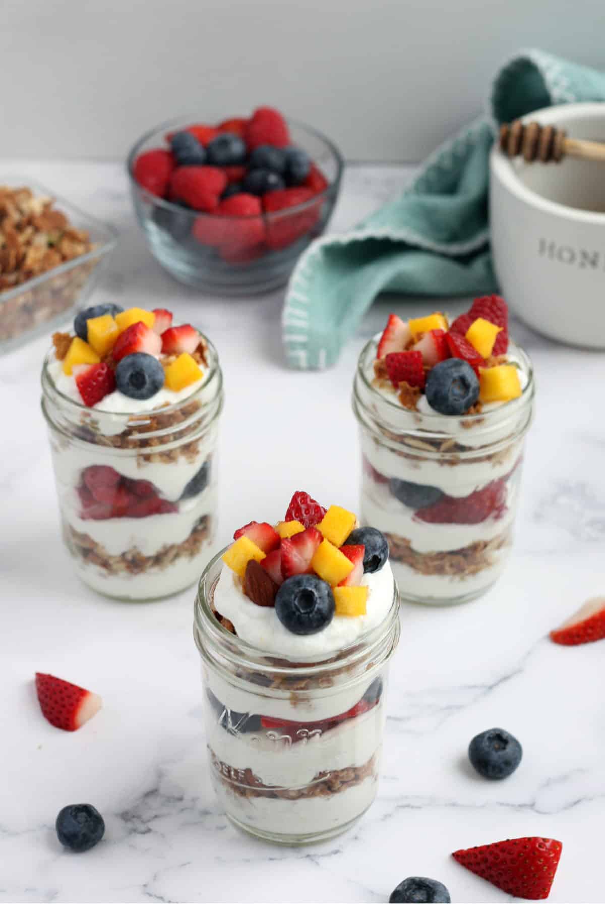 jars layered with fresh fruit, yogurt and granola
