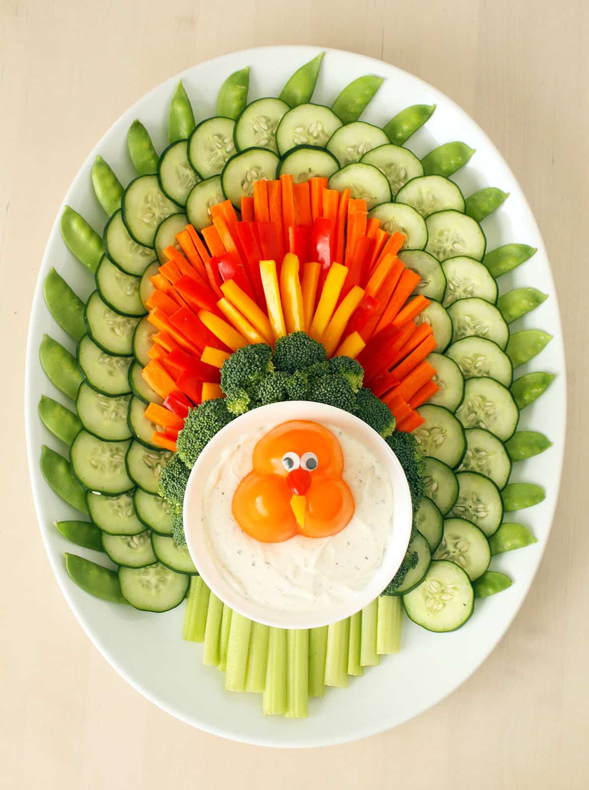 turkey veggie tray on a white platter with homemade ranch dip