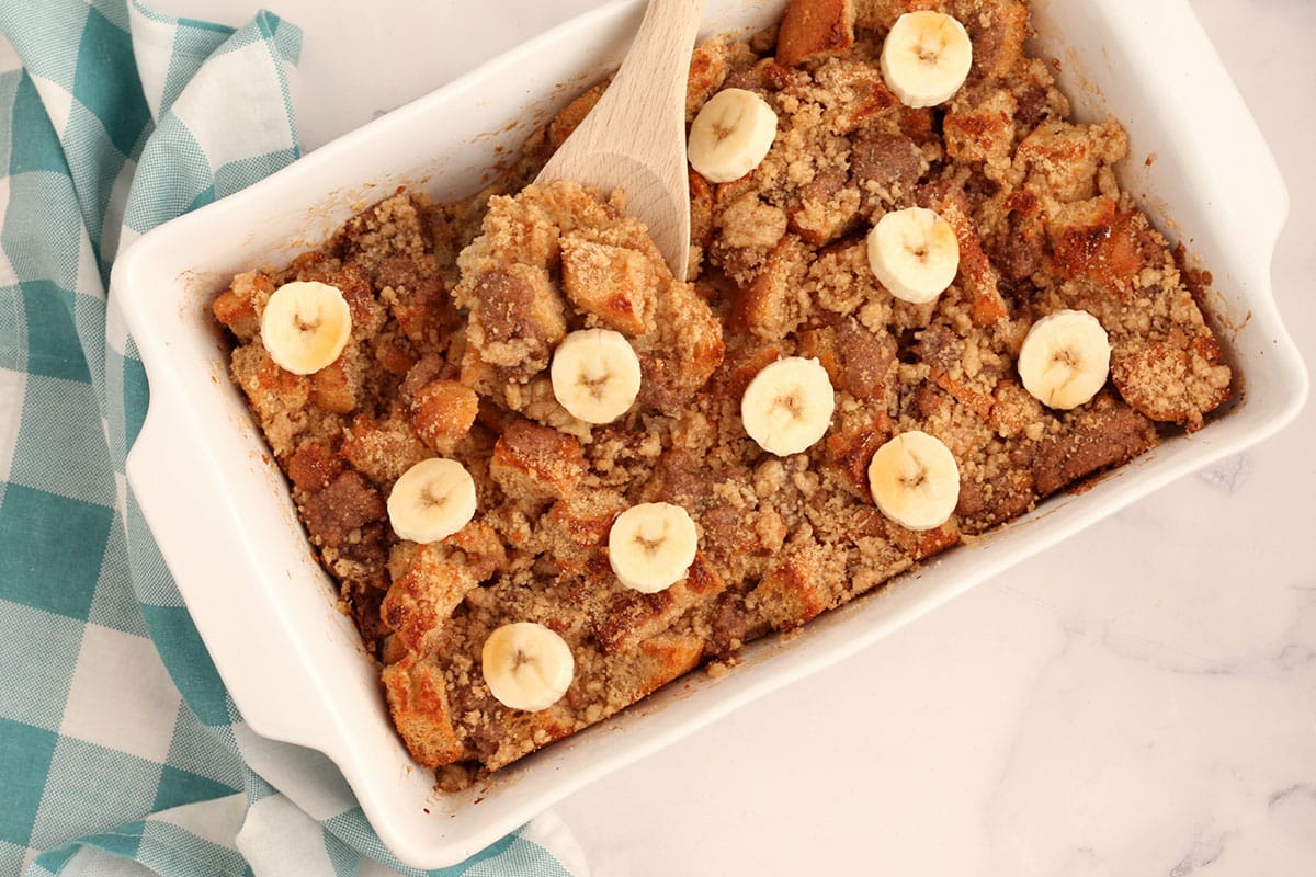 baked french toast in a casserole dish topped with fresh fruit