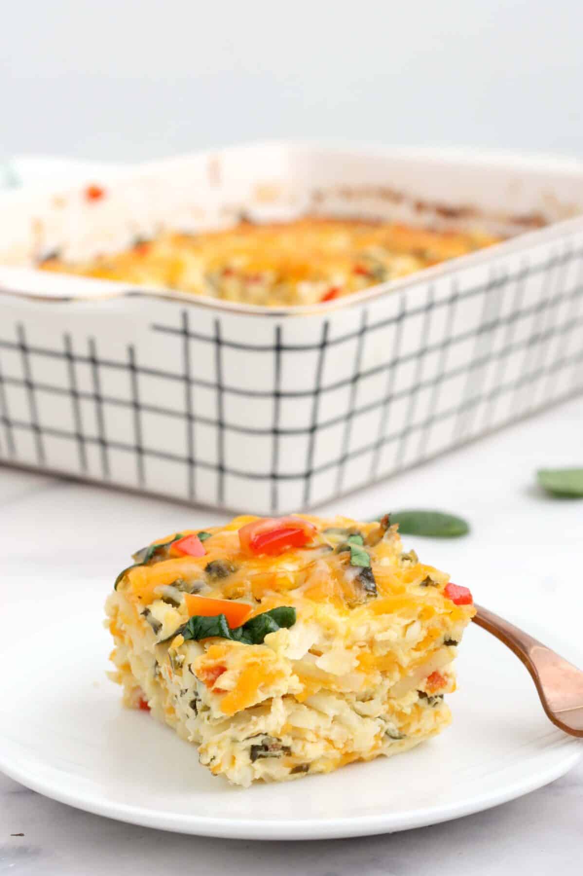 a slice of hashbrown breakfast casserole on a white serving plate