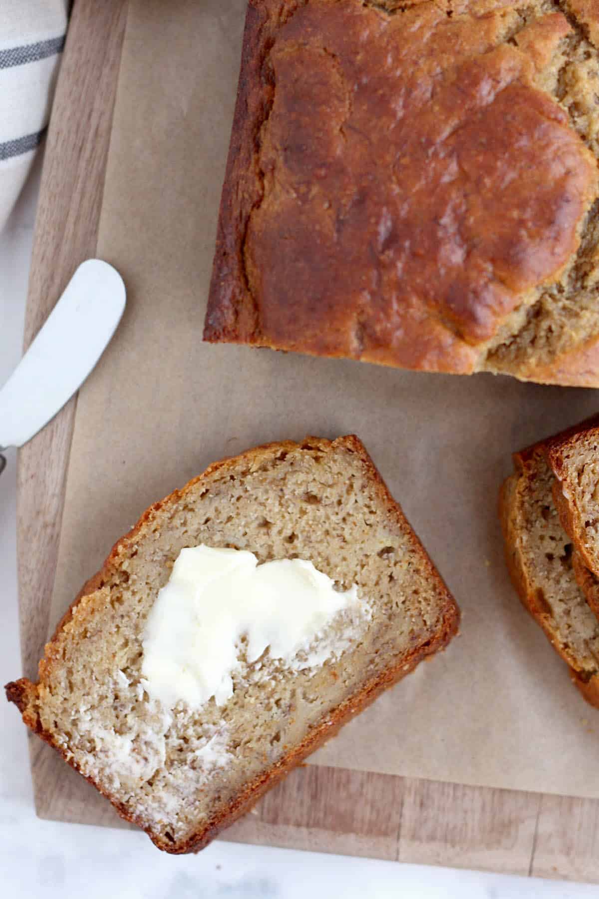 a slice of healthy banana bread with a smear of butter