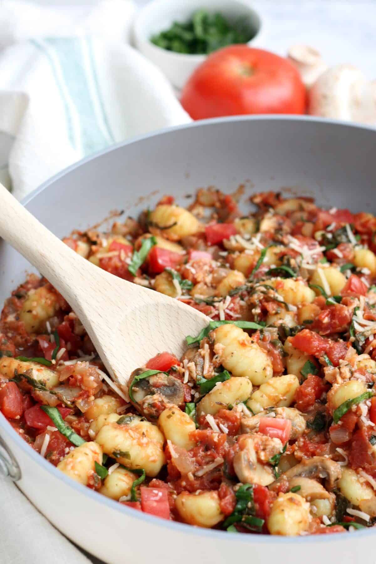easy gnocchi with mushrooms and tomatoes in a skillet