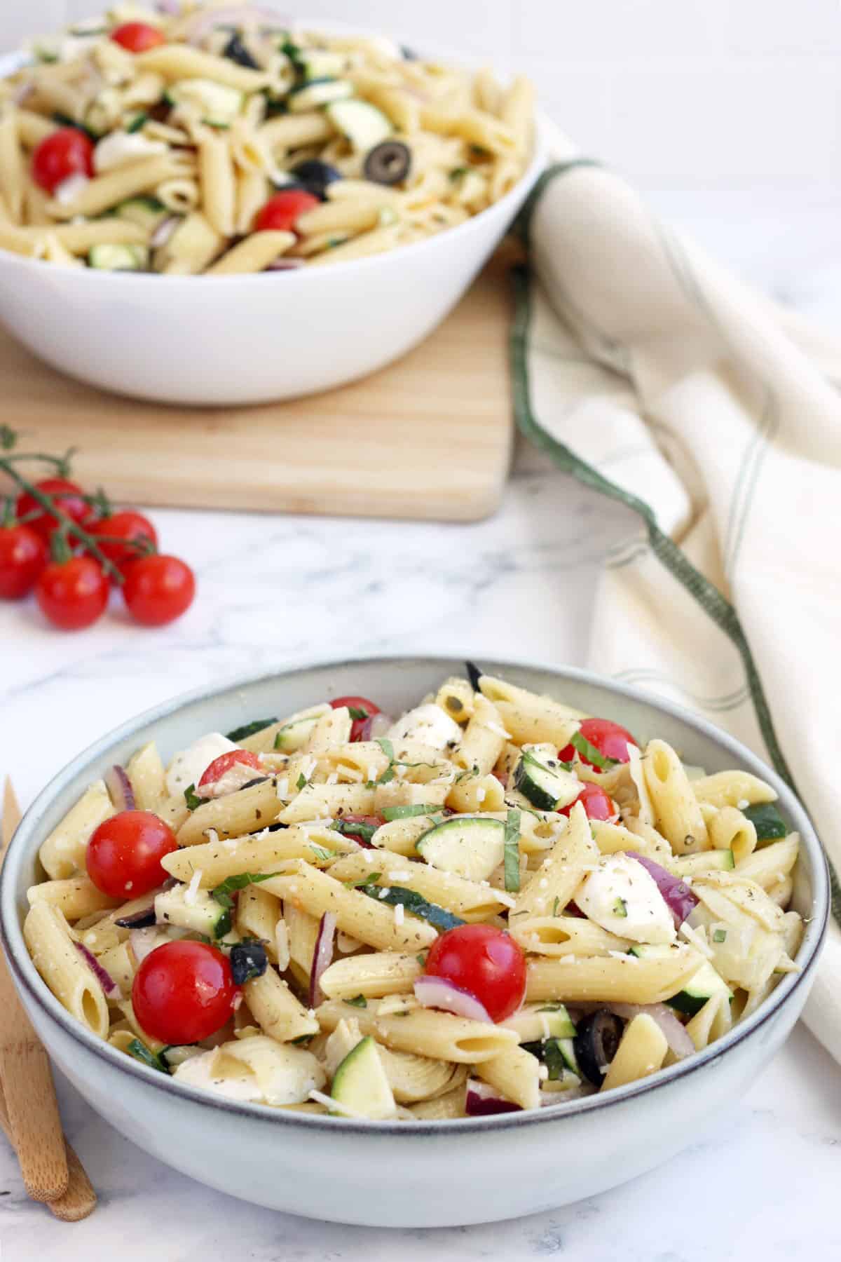 pasta salad in a ceramic bowl with a linen