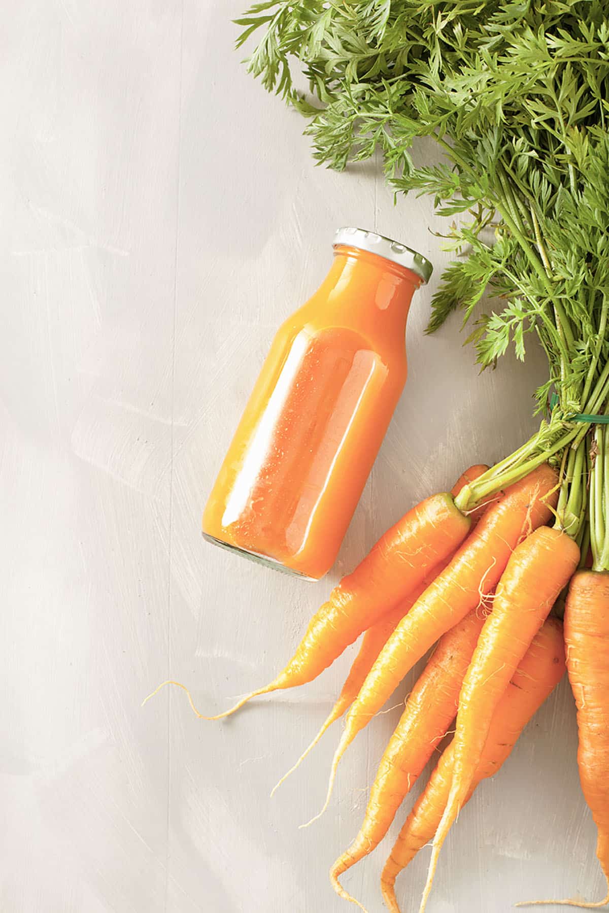 fruit and vegetable smoothie in glass jar, orange carrot