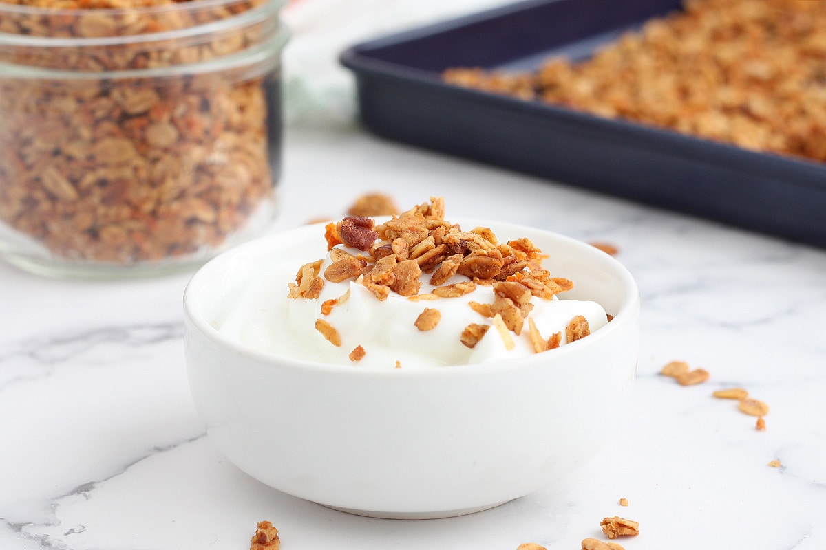 a bowl of yogurt topped with carrot cake granola