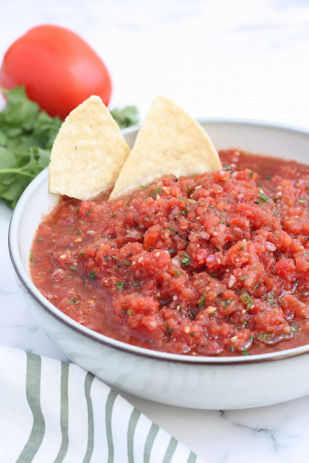 a bowl of homemade salsa with tortilla chips