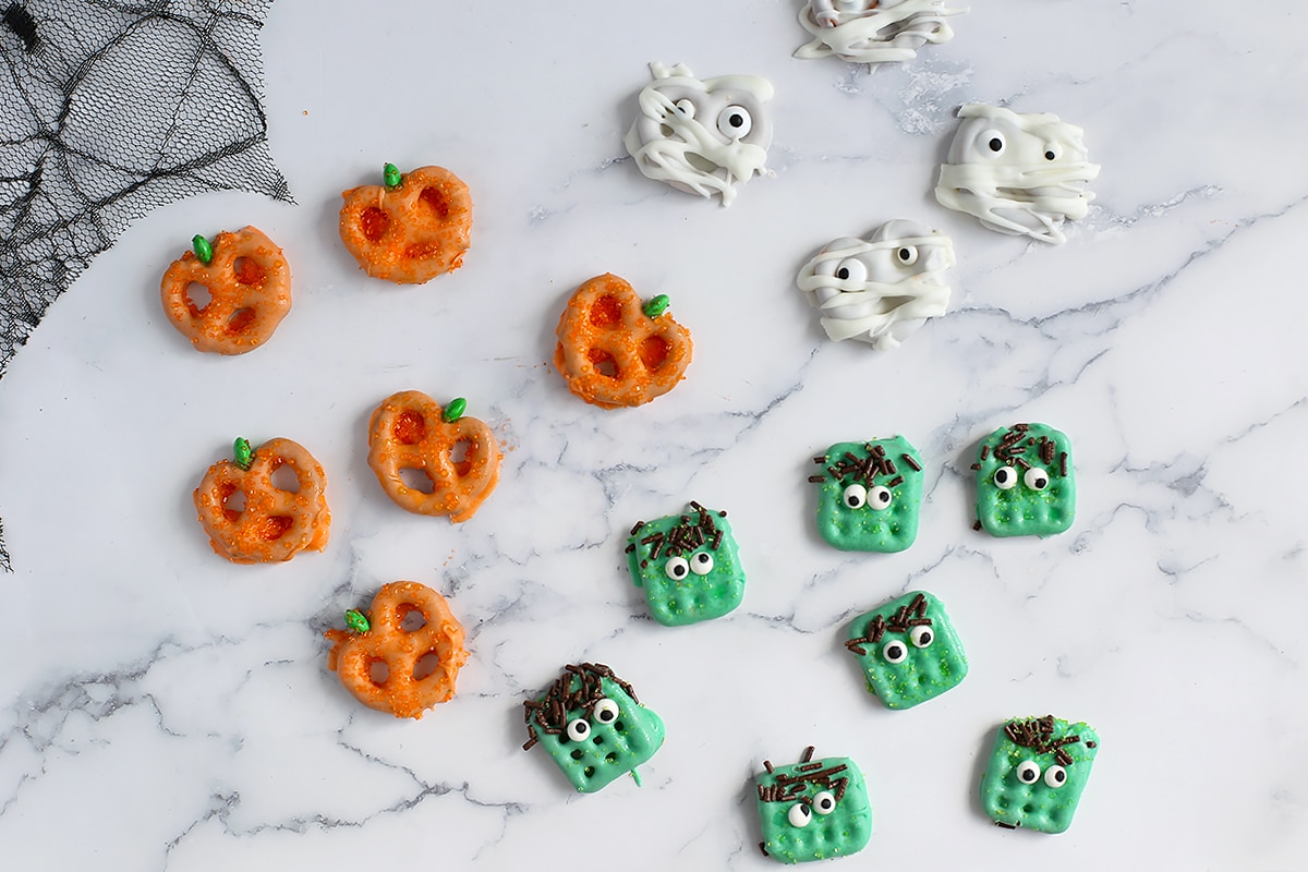 Chocolate Pretzels decorated like pumpkins, mummies, and monsters.
