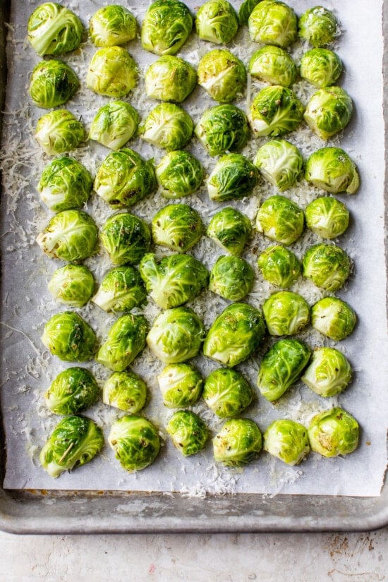 Brussels on sheet pan with parmesan cheese.