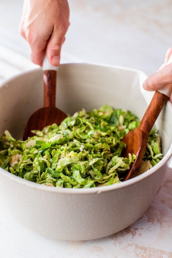 tossing brussels sprout salad