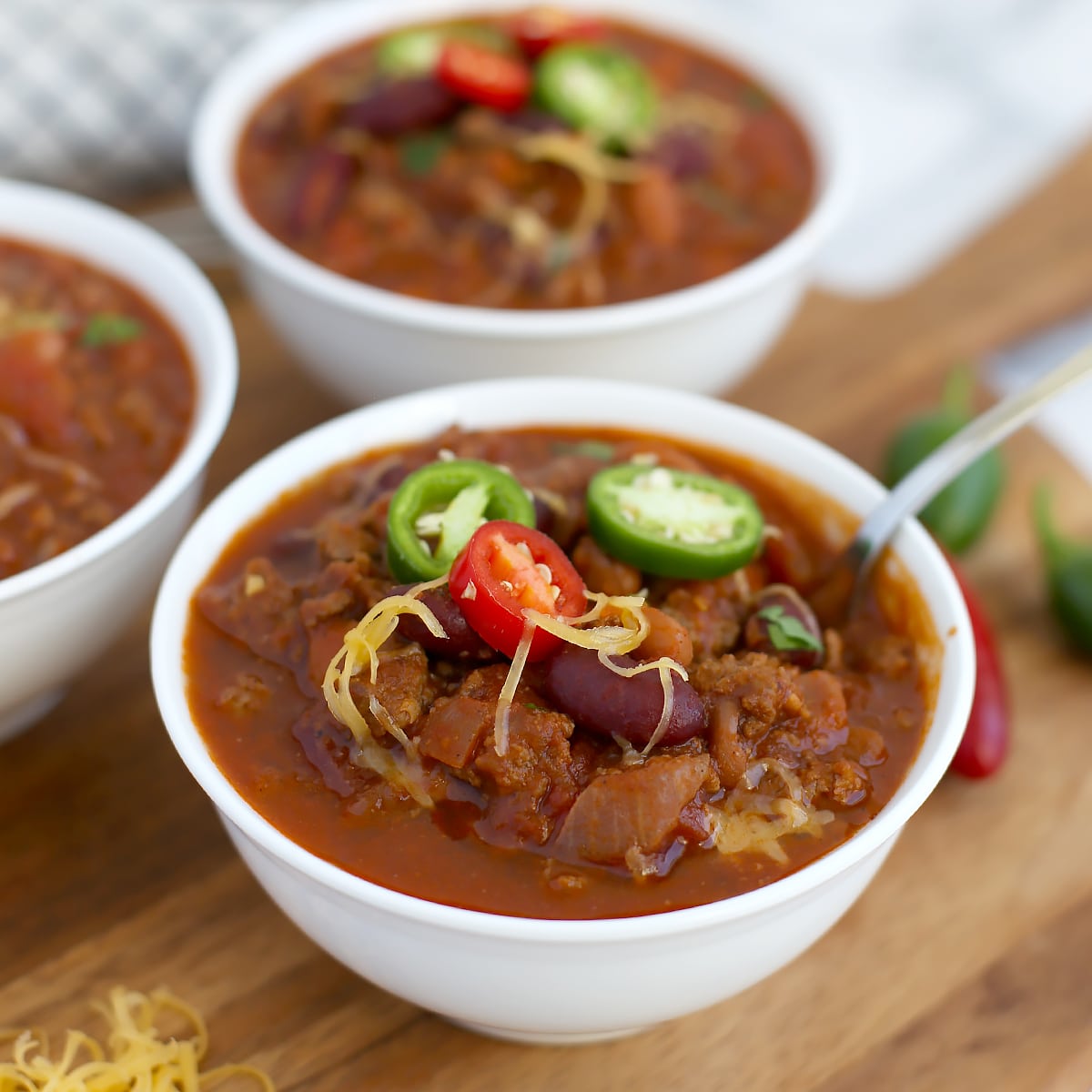 classic beef chili with shredded cheese and sliced jalapenos as a garnish